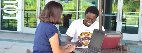 Photo of two TRIO Scholars students studying at the HUB.